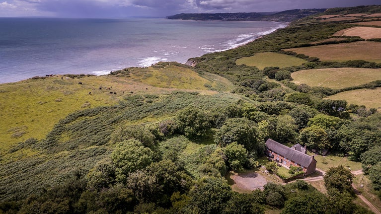 An aerial view of the St Gabriel's cottages and the coast, Dorset